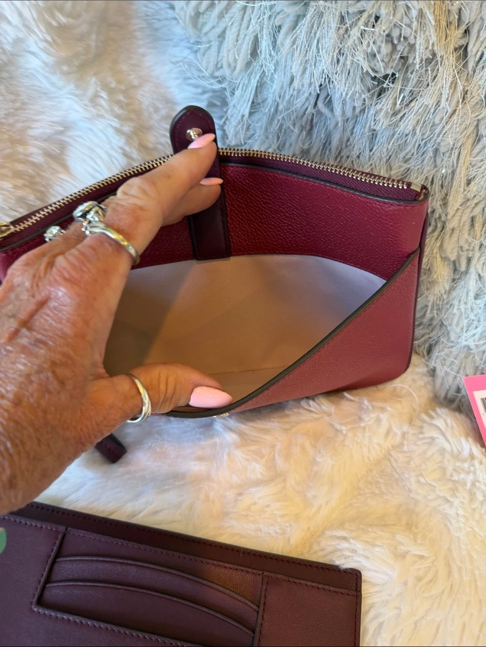 kate spade Burgundy Pebbled Leather Wristlet Clutch with Gold Tone Logo